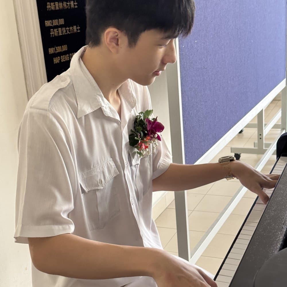 Jayden at the piano, in school uniform